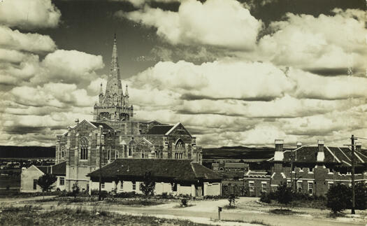 View of St. Andrew's Presbyterian Church, Forrest in the middle distance with other buildings around the church.