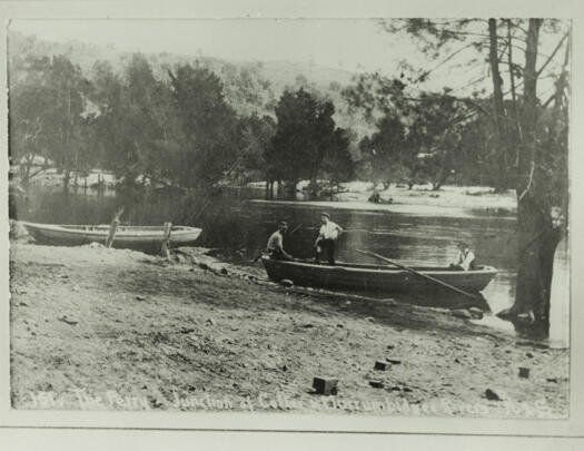 Ferry at the junction of the Cotter and Murrumbidgee Rivers. Shows two boats with three men sitting in one boat.