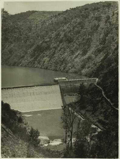 Cotter Dam spillway. Shows the dam wall before its height was raised. The photo is taken from a ridge above the dam.