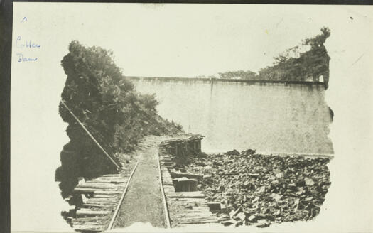 Cotter Dam. Shows a tram line running down to the dam wall.