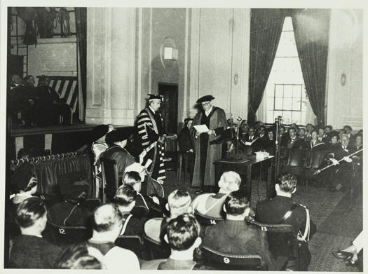 Installation of Lord Bruce as Chancellor of the ANU at the Albert Hall in 1952. A large crowd of academics are present.