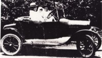 Canberra's first policeman Sergeant Cook and his wife and child in their car. The car is an older model Ford.