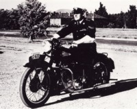 Motorcycle policeman Joe Medwin, dressed in his uniform, on his Ariel motorbike.