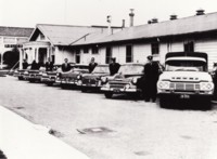 Police Station, Jolimont Building, Civic showing seven police officers each standing beside a police car 