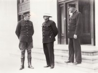 Three Policemen standing on steps of Parliament House talking