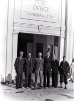 Post Office, Melbourne Building, corner of Northbourne Avenue and Alinga Street. Five men and a youth are standing in front of the entrance. Three of the men are identified as: A. Griffiths, W. Bradley and G. Sutherland.