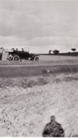 Two men in a car paying road workers at Adelaide Avenue / Cotter Road