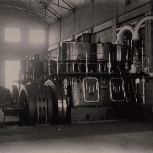 Interior of the Power House in Kingston showing a large generator.