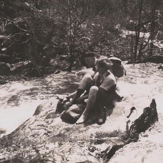 A couple at Pine Island putting on their shoes and socks after crossing the Murrumbidgee River.