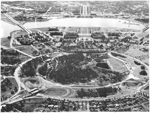 Aerial view from the south of Capital Hill and the construction of Capital Circle - the road around where New Parliament House was later built. State Circle is also visible.