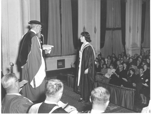 Erica Campbell receiving the Robin Tillyard Memorial Medal from Sir Robert Garran at the Albert Hall during the first conferral of degrees from the Canberra University College held in Canberra