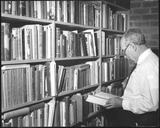 Dr John Cumpston reading at home.