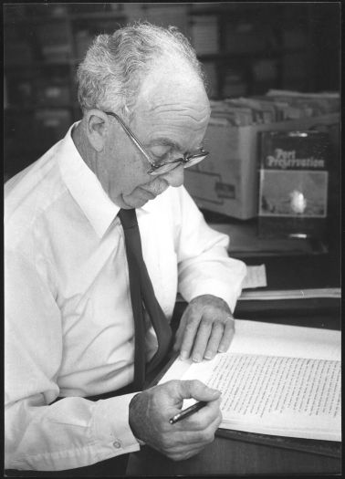 Dr John Cumpston reading at home