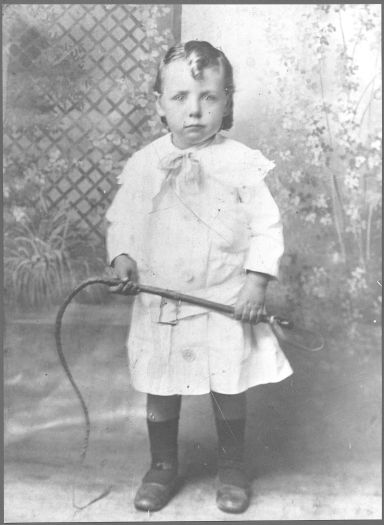 Little Peter Gallagher of \"Erindale\", Tuggeranong, holding a whip, aged 5 
