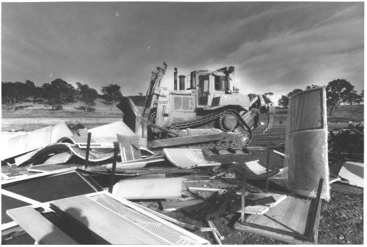 A bulldozer is burying petitions dumped unopened at Mugga tip