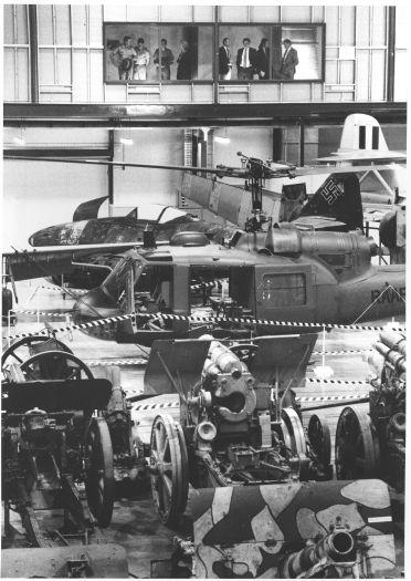 Opening of the John Treloar Centre for Conservation, Australian War Memorial Annexe, Mitchell. Photo shows people viewing exhibits from the 1st floor including a helicopter and artillery.