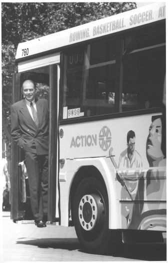 Wayne Berry MLA checks sports logo on ACTION bus