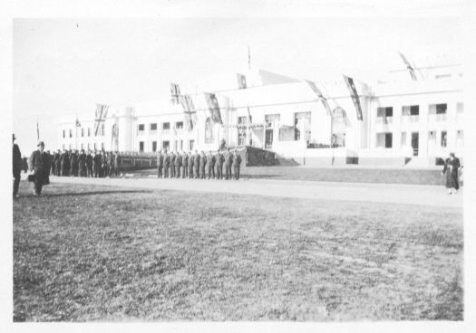 Rehearsal for Parliament House opening in 1927 showing men lined up in a parade in front of the building