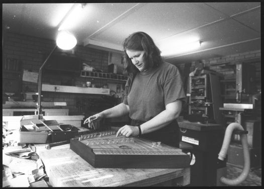 Instrument maker Gillian Alcock tuning a dulcimer