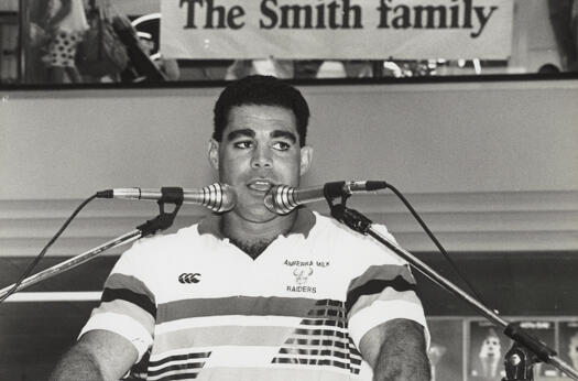 Mal Meninga presents cheque to the Smith Family