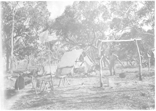 Two miners at their camp in front of their tent