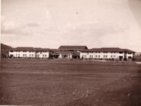 Front view of the Hotel Kurrajong showing a large open space in front of the building. No other buildings are visible.