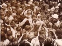 Photo shows a crowd of school children from Telopea Park with Santa Claus in the middle.