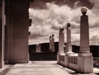 Steps of Parliament House showing ten pillars with lights on top.