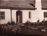 A typical house. The location is unknown. The house is in good condition with a well-kept front garden.