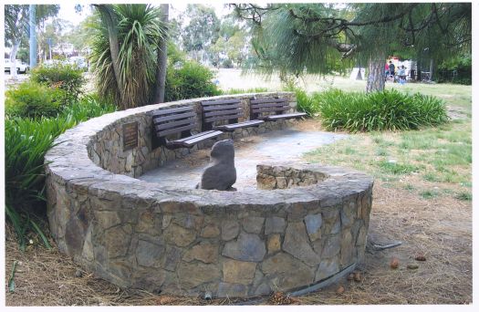 Plaque in stone wall and memorial seat near the Acton Ferry Terminal, Lake Burley Griffin.