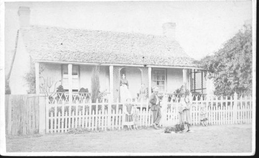 Elm Grove in Rutledge Street, Queanbeyan showing a man and woman and three small children in front of the house.
