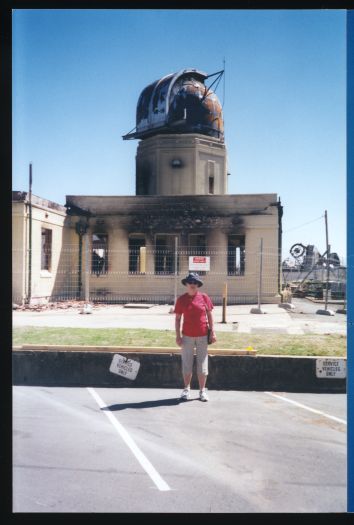 Helen Digan standing in front of damaged observatory

   


