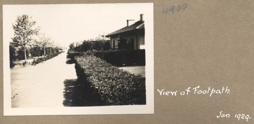 View along the footpath with houses on the right

