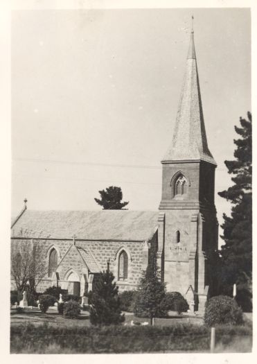 A side view of St John the Baptist Church of England and cemetery