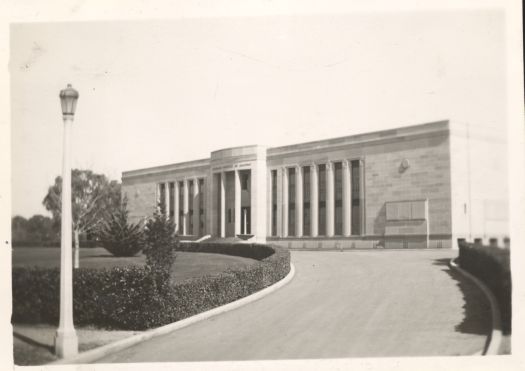 Shows the front of the Institute of Anatomy with the driveway