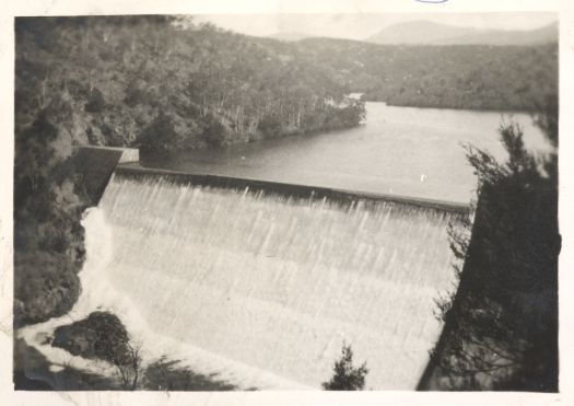 Cotter Dam with water pouring over the spillway