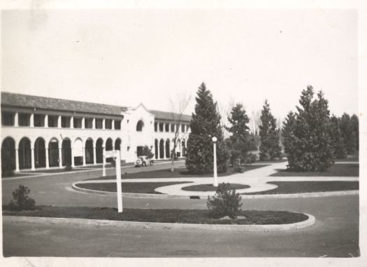 Shows the Sydney Building with a car in front