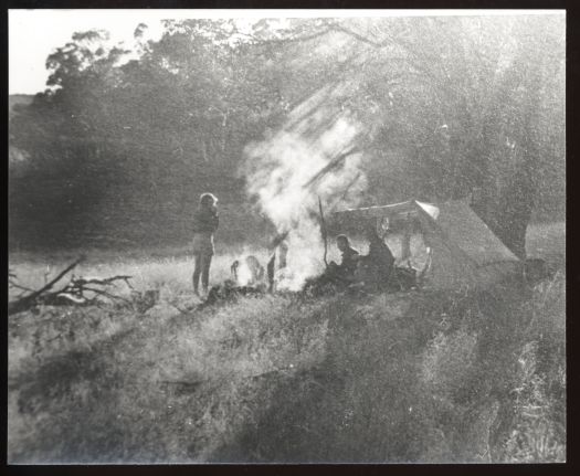 Camp site Cooleman Plains, three people around a camp fire.