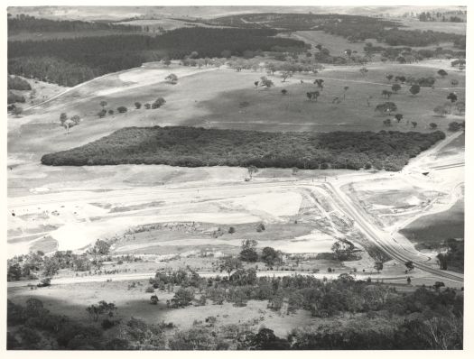 View from Black Mountain to Cork Plantation, Glenloch. Shows intersection of Caswell and William Hovell Drives. The future site of the National Arboretum is also visible.