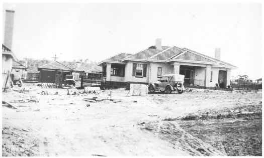 House at National Circuit, Blandfordia (now Forrest). Shows driveway and a vehicle near the garage. A builder's car is in the front garden. The house was occupied by the Garrans in the 1920s while Roanoke was being built.