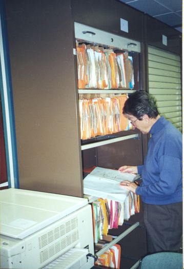 Val Emerton studying a file at the CDHS rooms in CMAG.