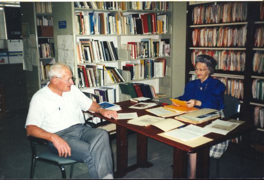 Tom Lawrence sitting in the CDHS office talking to Gloria Gorman