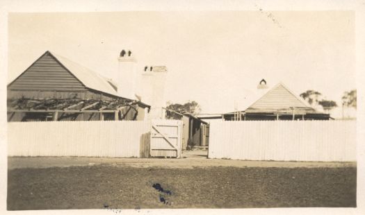 The home is hidden behind a wooden fence