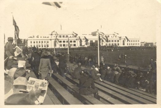 Parliament House with spectators sitting on seats in a stand