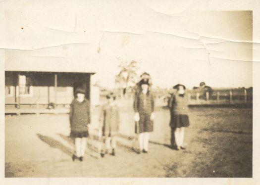 Four students standing in front of Carwoola School