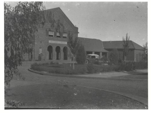 Brassey House with circular drive and car in front