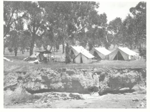 Four tents for the surveyors at Tuggeranong. An eroded gully is in the foreground.
