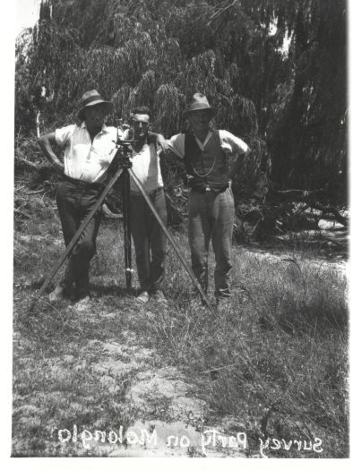 Survey team on the Molonglo River showing three men and a theodolite