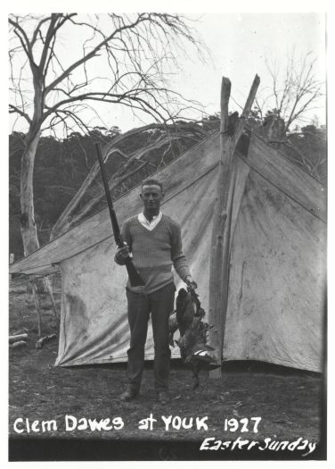 Clem Dawes outside his tent with shot gun and three ducks, Easter Sunday 1927