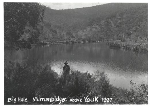Man standing in front of the Big Hole on the Murrumbidgee River near Yaouk.